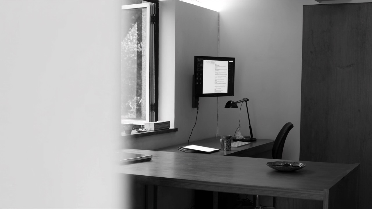 A person journaling on a tablet at a desk