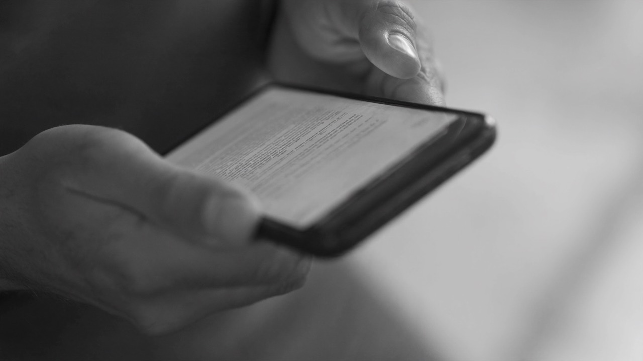 Two hands scrolling on a smartphone