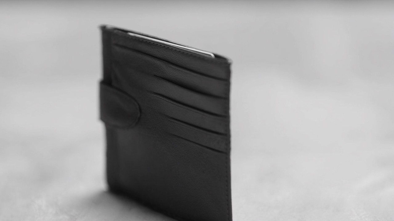 An open leather wallet with a few cards
